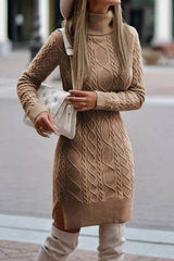 A woman wearing a brown cable knit turtleneck sweater dress with a white handbag.