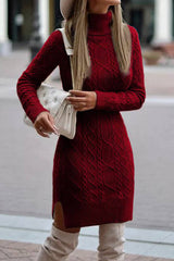 A woman wearing a red cable knit turtleneck sweater dress with a white handbag.