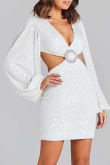 side view of a woman in a white sequined mini dress with a plunging neckline and cut-outs