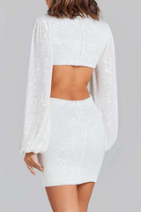 back view of a woman in a white sequined mini dress with an open back and long balloon sleeves