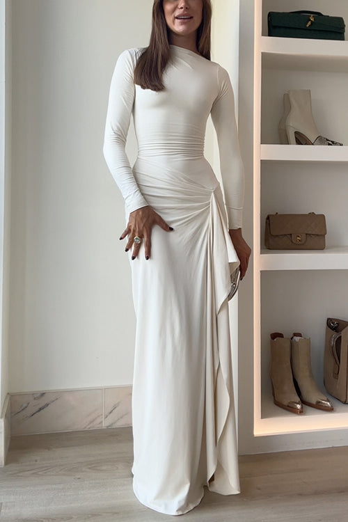 A woman in an ivory dress smiles.
