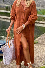 woman wearing a rust-colored long button-down dress with a high slit and a tote bag