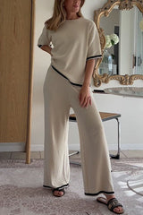 woman in beige loungewear set with black trim