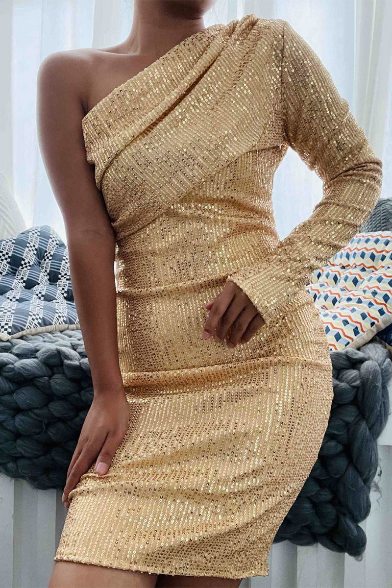 A woman in a gold sequined one-shoulder dress with a long sleeve.