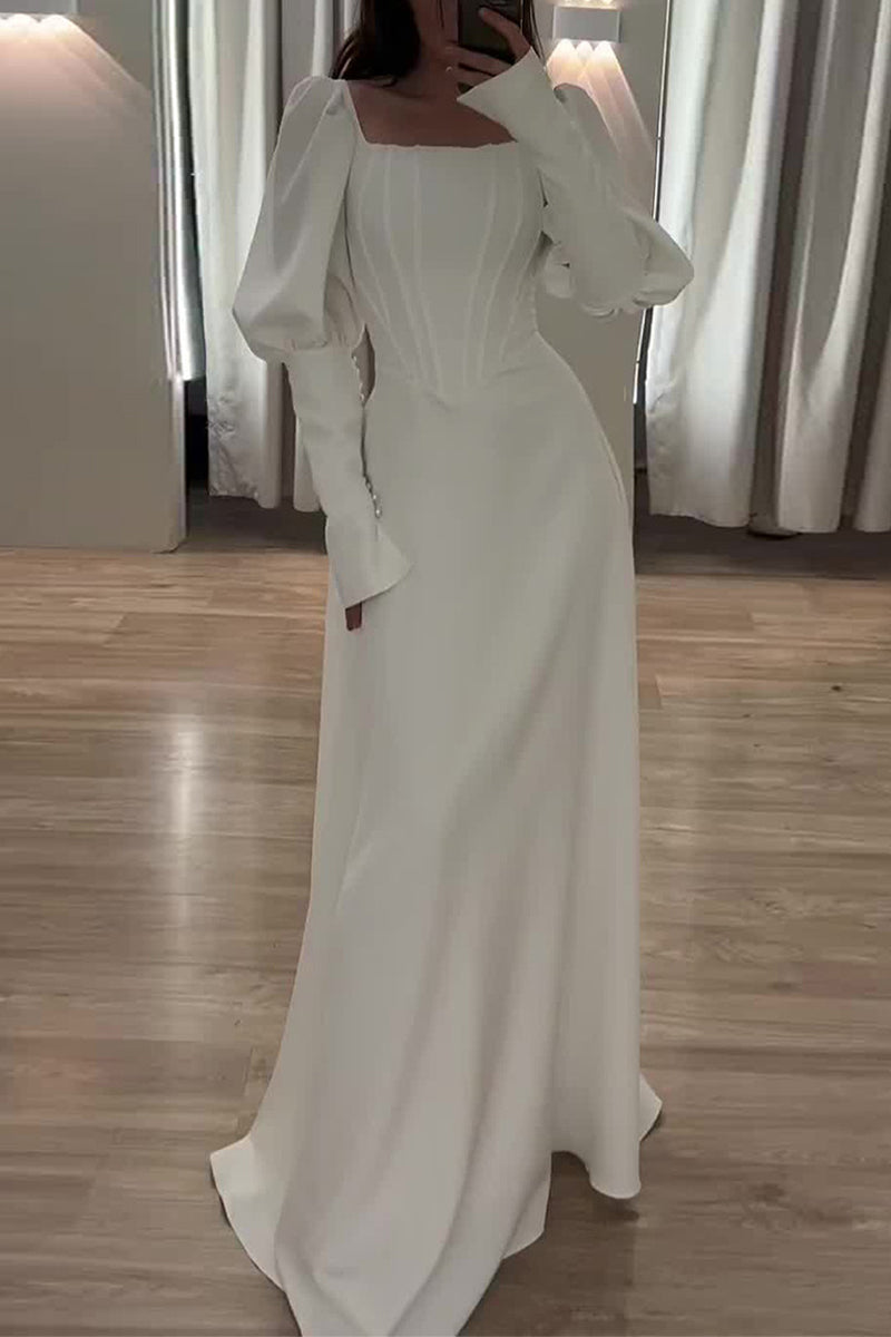 A woman in a white long-sleeved dress with a square neckline and a corset bodice.