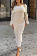 A woman wearing a white off-the-shoulder knit midi dress with long sleeves, paired with beige pointed-toe heels and a small cream crossbody bag.