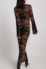 Woman in a tiger-print midi dress, back view.