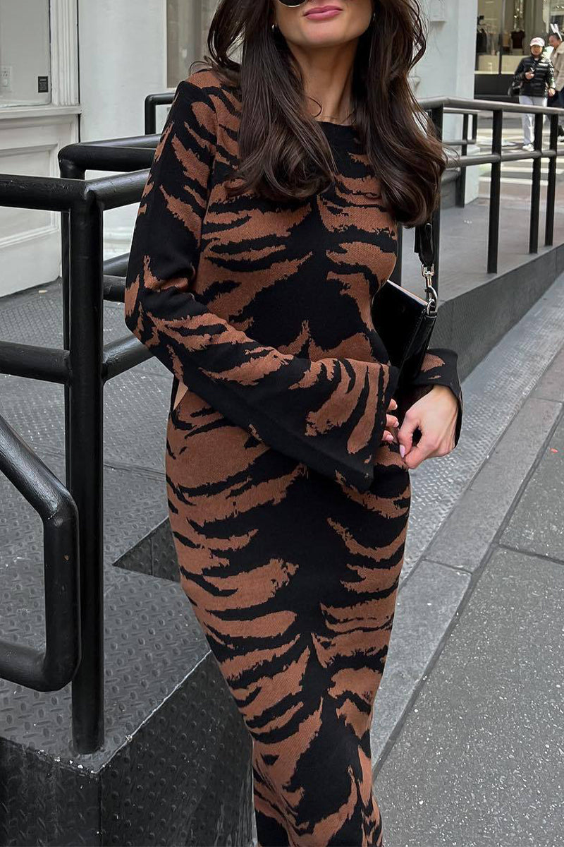 Close-up of a woman wearing a tiger-print midi dress.