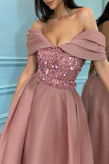 Close-up of the sequined bodice and off-the-shoulder neckline of a rose gold cocktail dress.