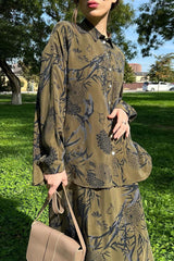 Close-up of the woman's outfit, showing the detail of the floral print on the shirt and skirt.