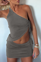 woman in a gray one-shoulder top and skirt