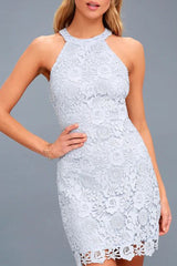 A woman models a light blue lace halter dress, front view.