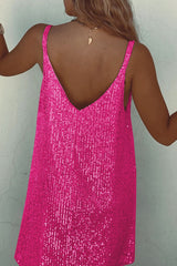 Back view of a woman in a hot pink sequined mini dress showing her back