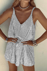Woman wearing a silver sequined mini dress, hands on hips