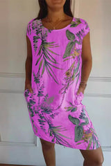 A woman wearing a pink floral print cap sleeve dress with pockets.
