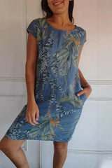 A woman wearing a blue floral print cap sleeve dress with pockets.