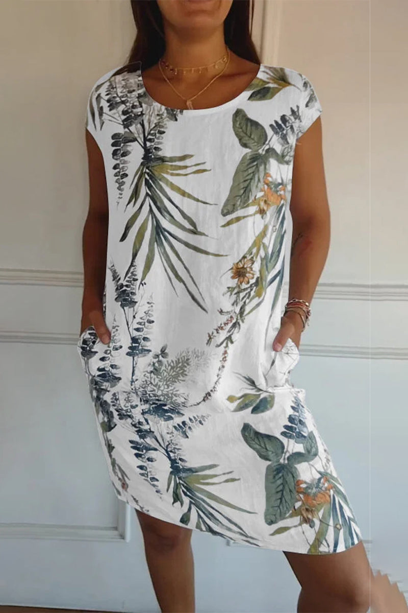 A woman wearing a white floral print cap sleeve dress with pockets.