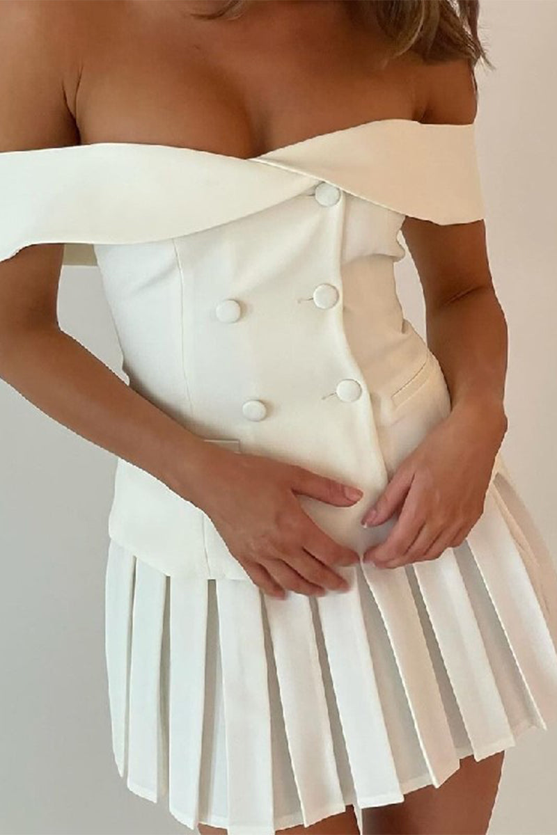 A close-up of a woman in a white off-the-shoulder blazer dress with a pleated skirt.
