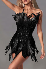 A woman wearing a black strapless sequined mini dress with feather accents, shown from the front.
