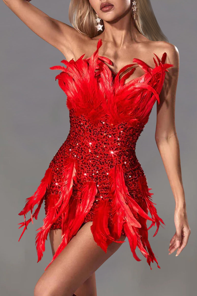 A woman wearing a red strapless sequined mini dress with feather accents, shown from the front.