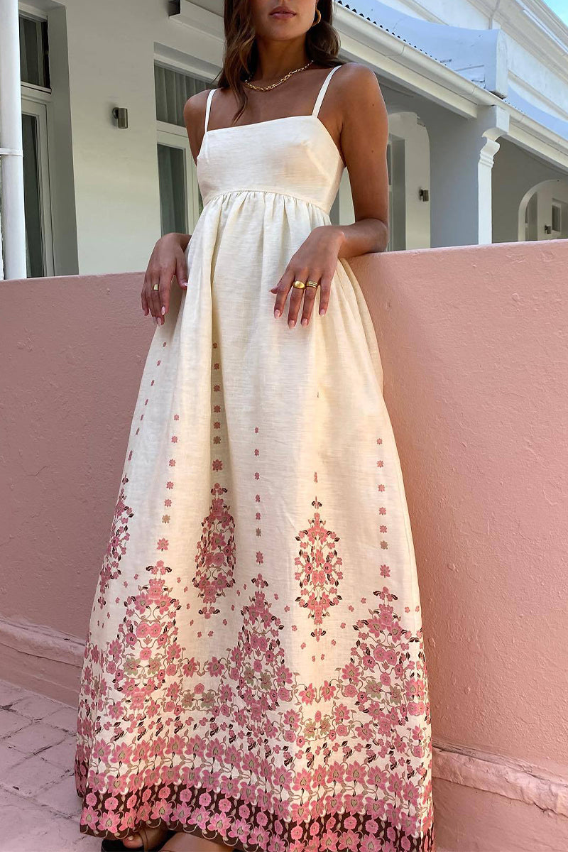 Woman wearing a cream maxi dress with pink floral print