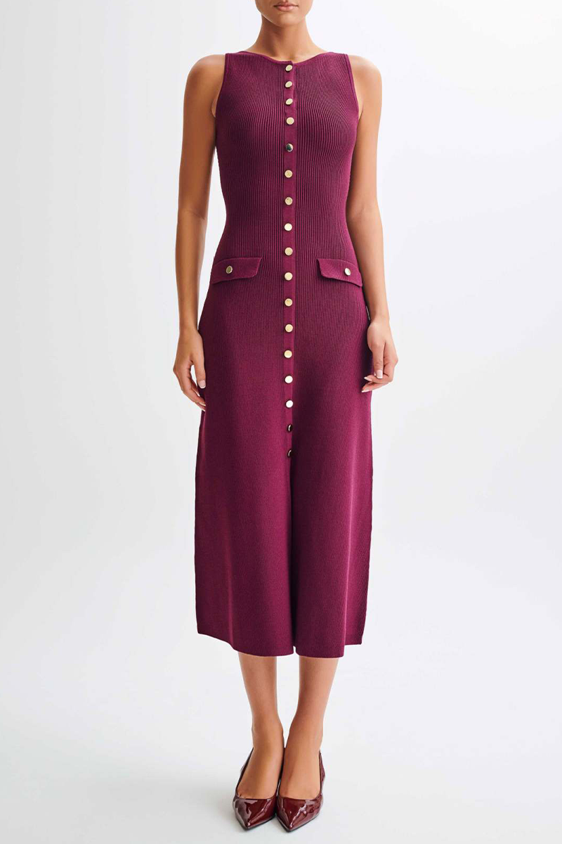 woman wearing a burgundy ribbed knit midi dress with gold buttons and pockets against a white background