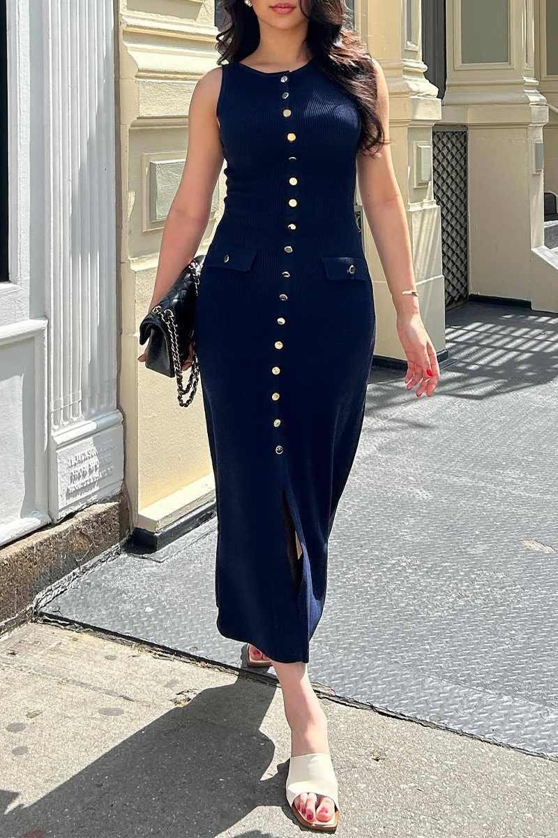 woman wearing a navy ribbed knit midi dress with gold buttons and pockets walking on a sidewalk