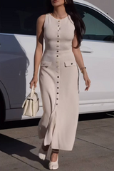 woman wearing a beige ribbed knit midi dress with gold buttons and pockets walking in front of a white car