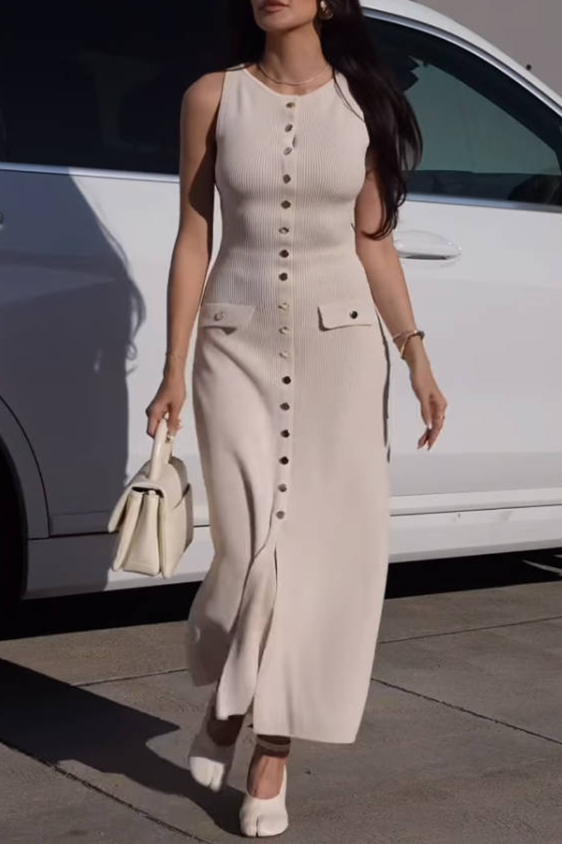 woman wearing a beige ribbed knit midi dress with gold buttons and pockets walking in front of a white car