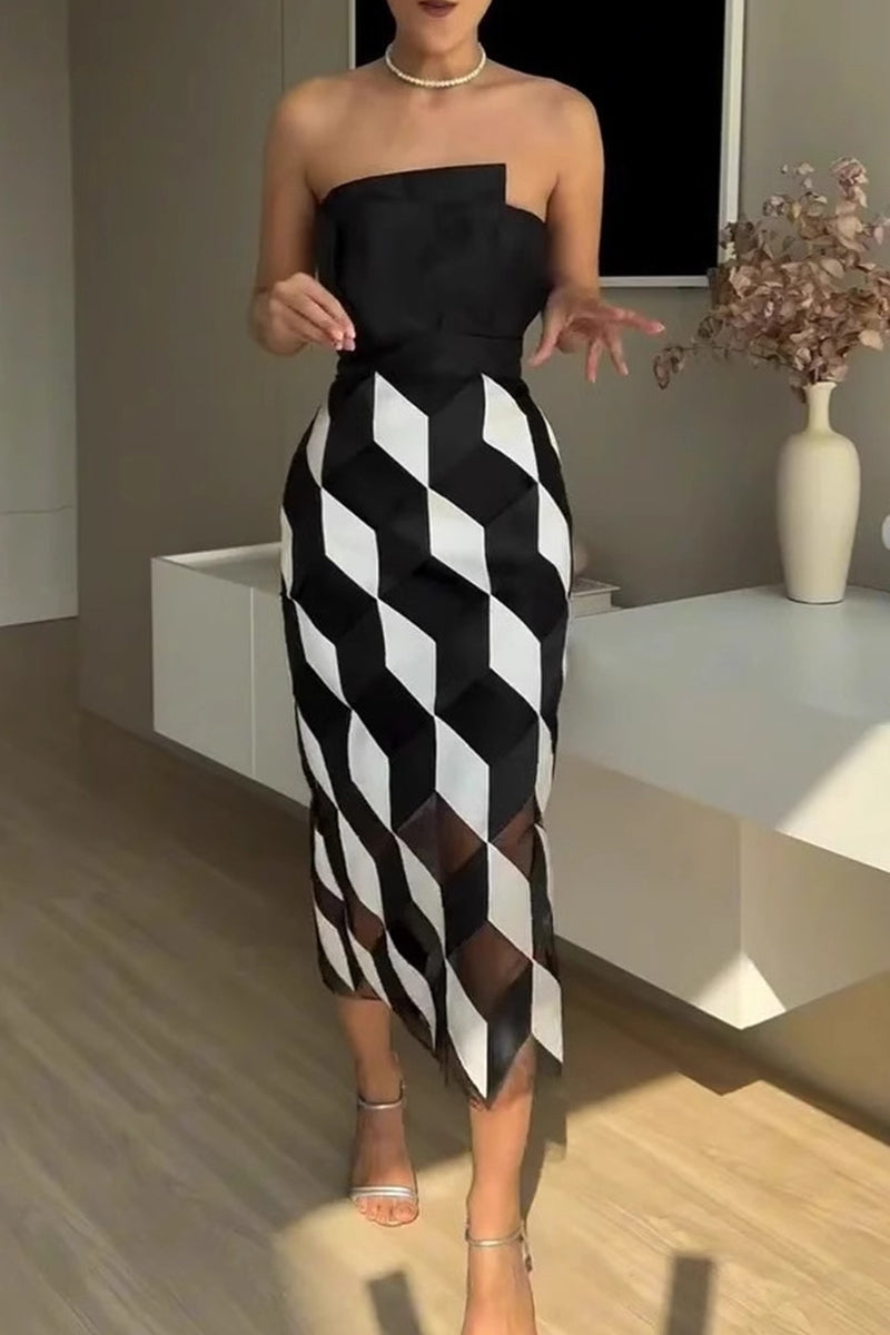 A woman poses in a strapless black and white geometric print sheath dress with sheer panels.