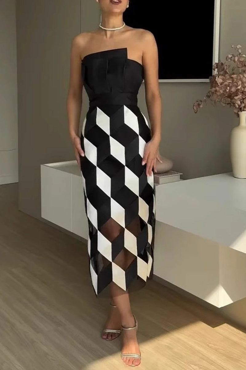 A woman models a strapless black and white geometric print sheath dress.