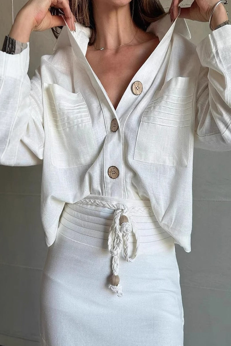 Close-up of the white linen-like button-down shirt with wooden buttons and textured pockets.