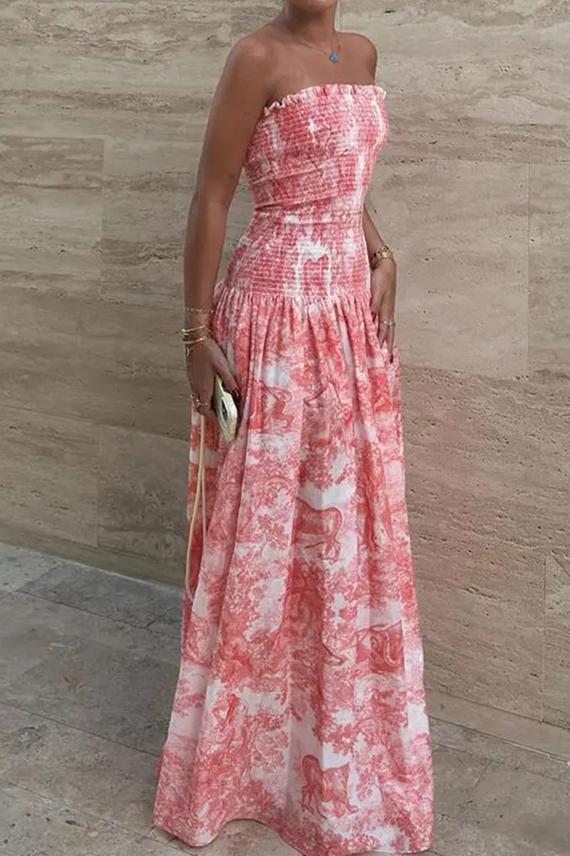 Woman wearing a pink and white patterned strapless maxi dress.