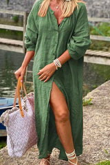 woman wearing a green long button-down dress with a high slit and a tote bag