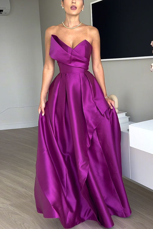Full shot of a woman modeling a purple satin gown with a draped bodice and a flowing A-line skirt.
