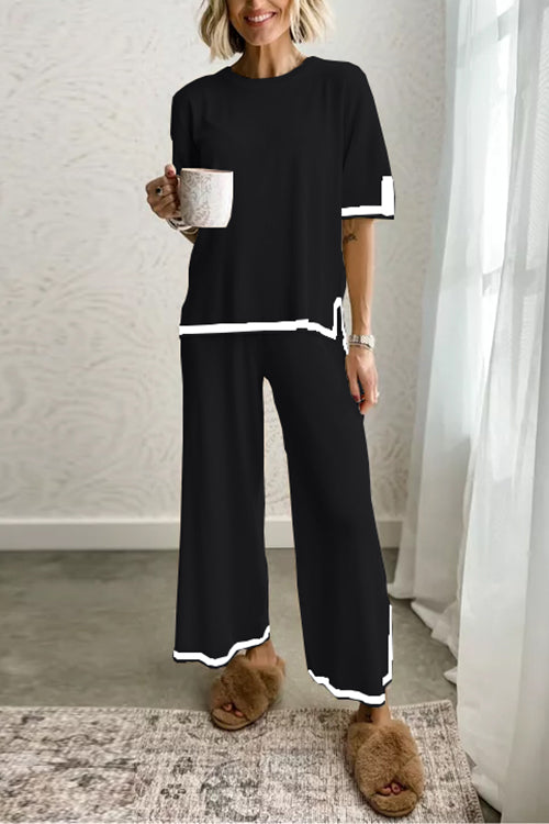 woman in black loungewear set with white trim