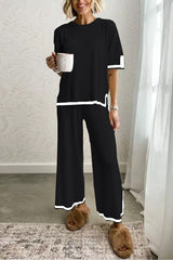 woman in black loungewear set with white trim