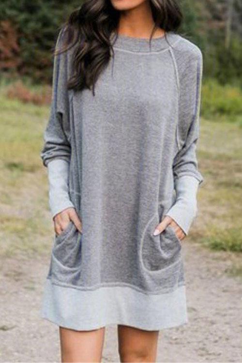 woman wearing a gray long-sleeved dress with pockets