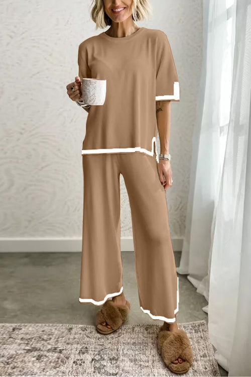 woman in tan loungewear set with white trim