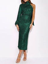 Woman wearing a green sequined one-shoulder dress with a high neck and long sleeve