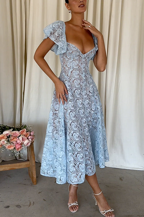 Woman in a light blue lace midi dress with puff sleeves and a sweetheart neckline