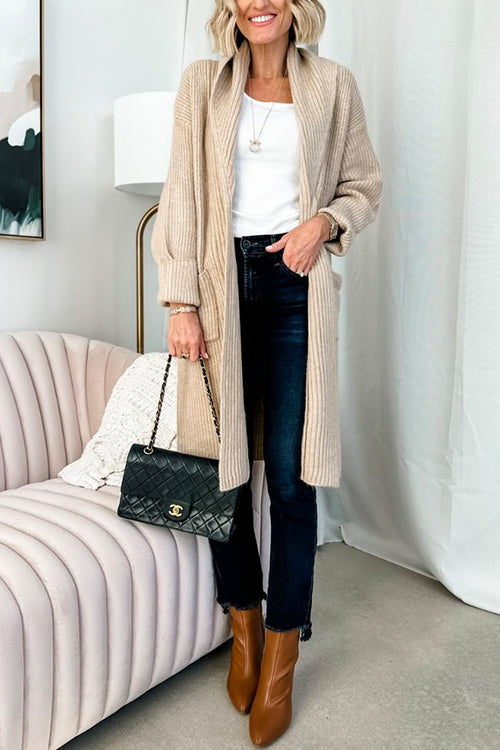 woman holding a black quilted handbag