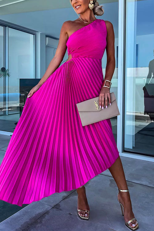 A woman in a fuchsia one-shoulder pleated dress with a cut-out detail and a beige clutch.