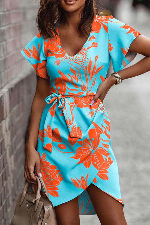 woman in a blue and orange floral print dress