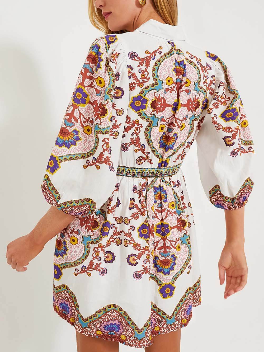 Back view of the dress, highlighting the puff sleeves and the continuation of the paisley print.