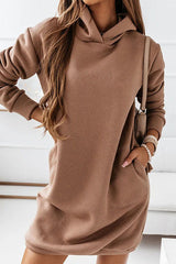 a woman wearing a brown hoodie dress