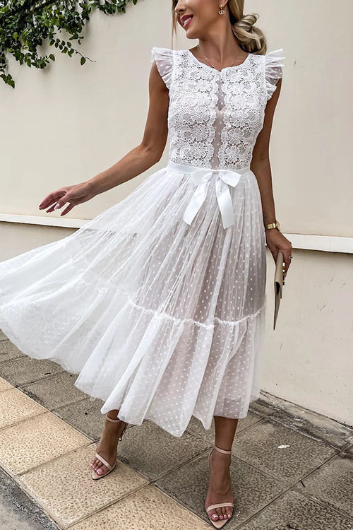 woman in a white lace and tulle midi dress with a bow