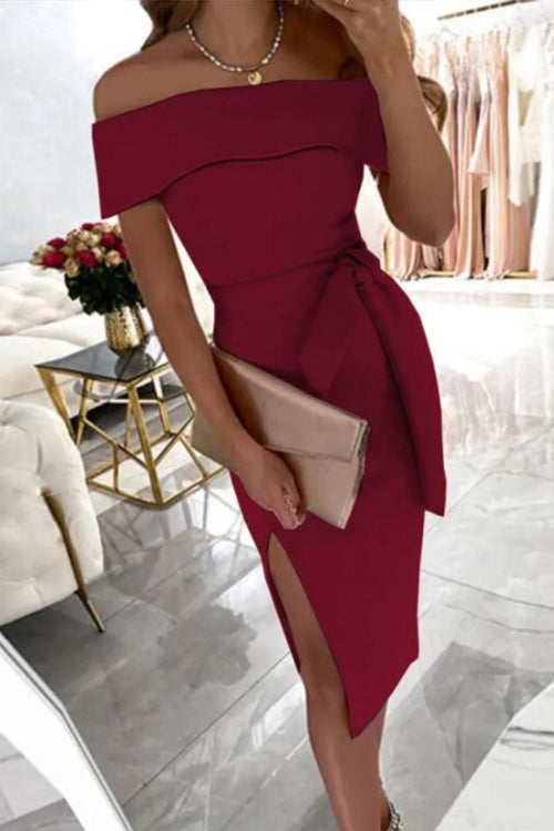 woman in maroon off-the-shoulder dress with a bow belt and high slit
