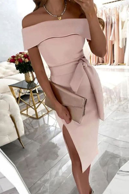 woman in light pink off-the-shoulder dress with a bow belt and high slit