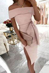 woman in light pink off-the-shoulder dress with a bow belt and high slit